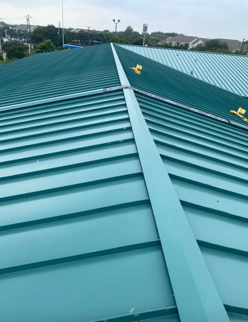 Green commercial metal roof ridge and valley for Metal Roof Repair in Ames
